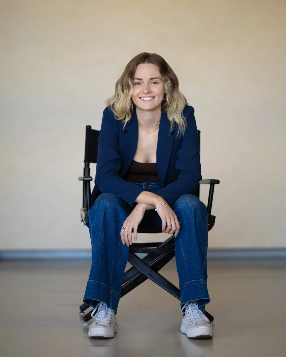 Bre smiling in a director's chair