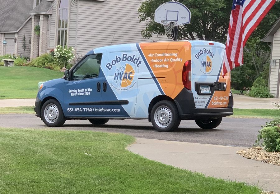 A Bob Boldt HVAC van parked in a customer's driveway
