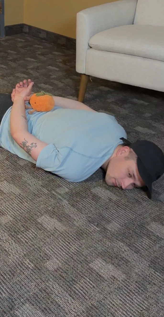 Joe face down on the office floor, arrested by a plush Officer Ollie